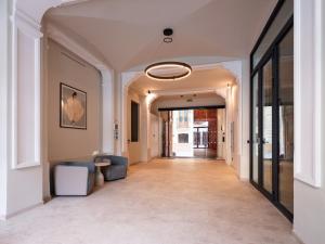 a hallway with a couch and a light fixture at Numa Valencia La Xerea in Valencia