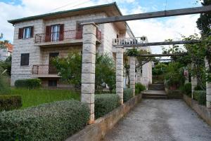 a stone house with an archway in front of it at Moretino Supetar in Supetar