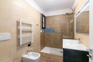 a bathroom with a toilet and a sink at Caribe Village in Lido di Jesolo