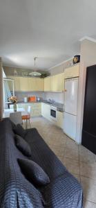 a kitchen with a bed with pillows on it at Filis mare apartment in Xylokastro