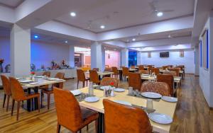 a dining room with tables and chairs in a room at TreeHouse Morina, Vithalapur in Vithalpur