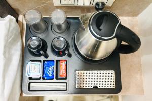 a tea kettle and other items on a stove at Hotel Enclave Bikaner in Bikaner