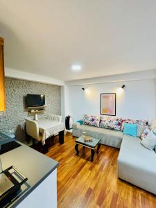 a living room with a couch and a table at Hidden House Tirana Castle in Tirana