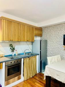a kitchen with a sink and a refrigerator at Hidden House Tirana Castle in Tirana