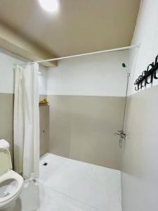 a bathroom with a toilet and a shower at Hidden House Tirana Castle in Tirana +19 photos