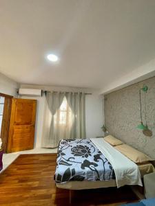 a bedroom with a bed and a window at Hidden House Tirana Castle in Tirana