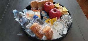 a plate of food on a table with apples and bread at B&B Casa Derosas in Golfo Aranci
