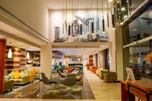 a lobby of a hotel with couches and chairs at Hilton Garden Inn Nairobi Airport in Nairobi