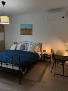 a bedroom with a bed and a table and a desk at Kuća za odmor Šofika in Sveti Ivan Žabno +15 photos