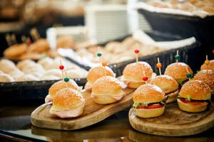 a group of sandwiches on wooden plates with toothpicks at NH Marina Portimao Resort in Portimão
