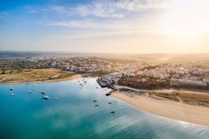 an aerial view of a beach with boats in the water at NH Marina Portimao Resort in Portimão