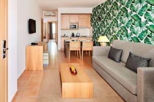 a living room with a couch and a table at NH Marina Portimao Resort in Portimão