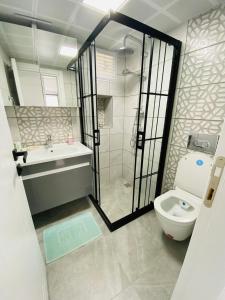a bathroom with a shower and a toilet and a sink at E-My Marina Cesme in Cesme