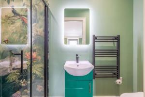 a bathroom with a sink and a shower at Boutique Stays at 56B in Newtownards +36 photos