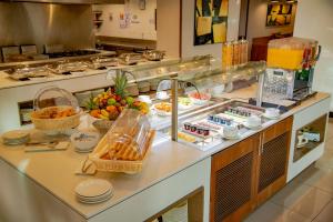 a kitchen with a buffet of food on a counter at Hilton Garden Inn Nairobi Airport in Nairobi