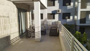 a balcony of a building with a blue wall at Wind Rose Montenegro in Igalo
