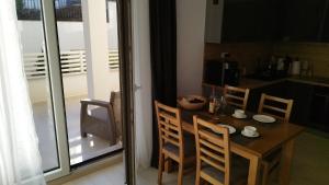 a dining room table and chairs in a kitchen at Wind Rose Montenegro in Igalo +1 photo