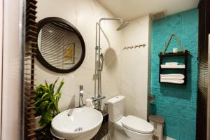 a bathroom with a sink and a toilet and a mirror at La Bonté Boutique Home Ho Chi Minh in Ho Chi Minh City +57 photos