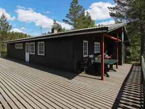 a small black building with a desk on a deck at 8 person holiday home in ÅSERAL in Hamkoll +48 photos