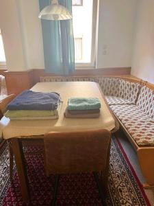 a table with two towels on top of it next to a couch at Spacious Local Lounge Apartment in Kelkheim