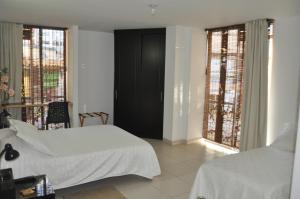 Voodi või voodid majutusasutuse Hotel Meson de las Flores toas