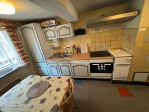 a small kitchen with a table and a sink at Spacious Local Lounge Apartment in Kelkheim