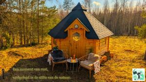 a cabin in the woods with a table and chairs at Kota in Lappeenranta