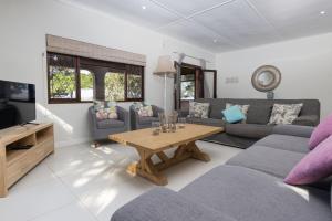 a living room with a couch and a coffee table at KERYNMERE, Zinkwazi Beach in Zinkwazi Beach +21 photos