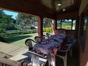 a table and chairs on the back porch of a house at KERYNMERE, Zinkwazi Beach in Zinkwazi Beach