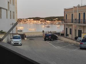 two cars parked in a parking lot next to a body of water at Dimora Zoe sea view by CASASI Vacanze Otranto in Otranto
