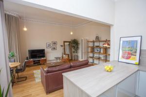 a living room with a couch and a table at Spacious Period Property in Glasgow in Glasgow