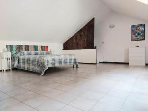 a bedroom with a bed and a tiled floor at La Brezza di lago in Baveno