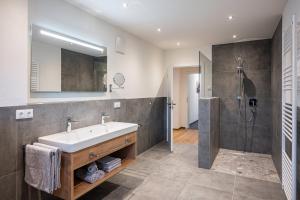 a bathroom with a sink and a shower at RUBEN 15 Ferienwohnungen in Oberstdorf +21 photos