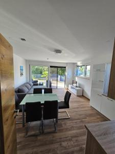 a living room with a table and a couch at Apartman Mara in Malinska