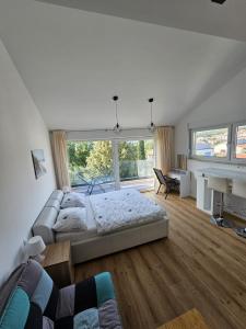 a large bedroom with a bed and a couch at Apartman Mara in Malinska