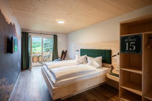 a bedroom with a bed and a clock on the wall at RUBEN 15 Ferienwohnungen in Oberstdorf