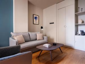 a living room with a couch and a table at Numa Valencia La Xerea in Valencia