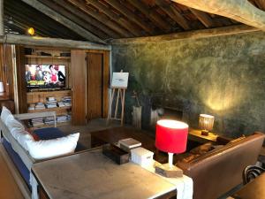 a living room with a couch and a table at Casa 7suítes - Vista para Barra do Sahy in Barra do Sahy