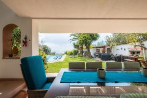 a patio with a table and chairs and a pool at Beachfront villa with direct access -Private pool & Zen Area in Quartu SantʼElena