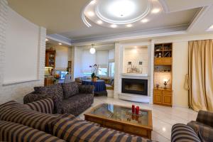 a living room with couches and a fireplace at Kalamata Panorama Villa in Kalamata +57 photos