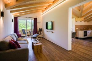 a living room with a couch and a table at RUBEN 15 Ferienwohnungen in Oberstdorf