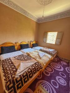 Postel nebo postele na pokoji v ubytování Dar Akiode Toubkal