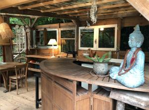 a room with a statue sitting on a wooden table at Yourte dans la forêt in Rennes-les-Bains