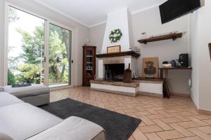 a living room with a couch and a fireplace at Blue Moon Relais in Santa Maria di Scacciano