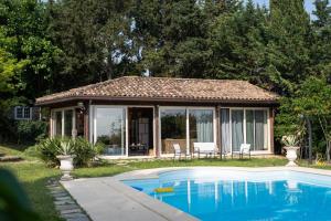 a house with a swimming pool in the yard at Blue Moon Relais in Santa Maria di Scacciano