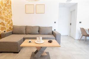 a living room with a couch and a coffee table at Stone and Sea Kos Retreat Serenity in (( Kermetés )) +38 photos
