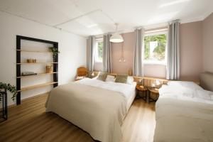 a bedroom with two beds and a table at Äuchen am Rosenthal in Monschau