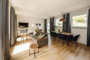a living room with a couch and a table at Äuchen am Rosenthal in Monschau