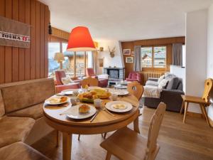 a living room with a table with food on it at Apartment La Toura by Interhome in Verbier