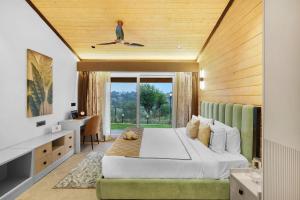 a bedroom with a bed and a desk and a window at Serene 2BHK with Garden and Hilltop Jacuzzi in Palāhu +31 photos